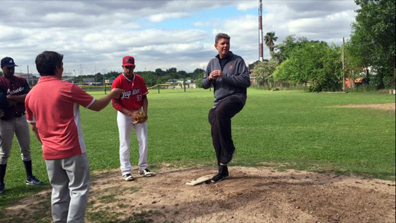 Joel Bradley instructing baseball players in Argentina